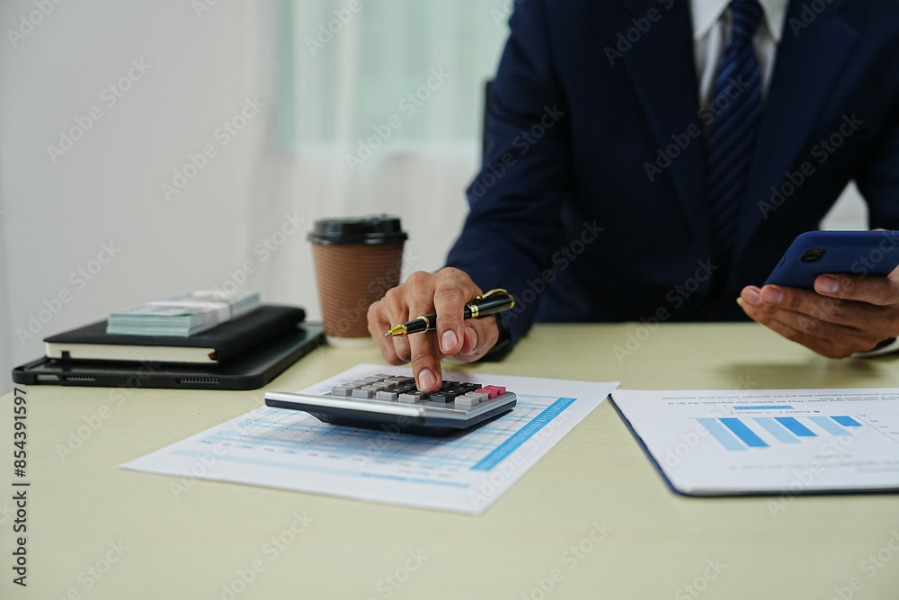 professional businessman is sitting in his office, confidently smiling while working on his laptop. A successful entrepreneur and leader, he embodies corporate success and happiness professional businessman is sitting in his office, confidently smiling while working on his laptop. A successful entrepreneur and leader, he embodies corporate success and happiness