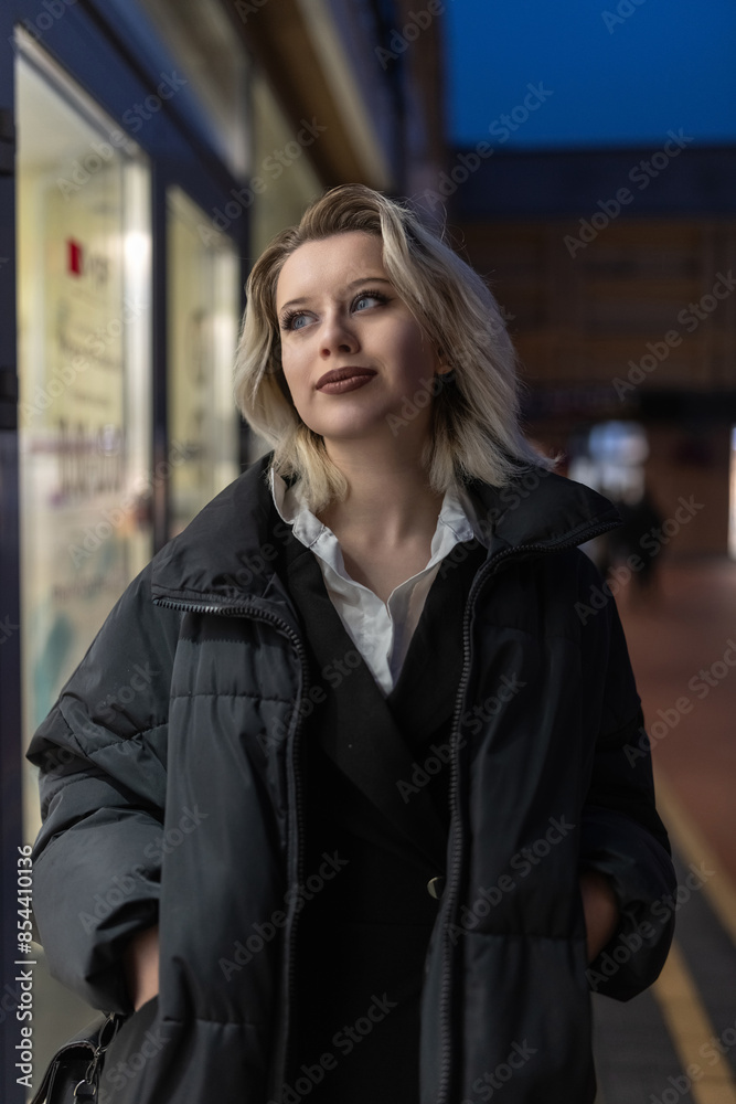 Portrait of a young beautiful blonde girl in an evening spring city. Portrait of a young beautiful blonde girl in an evening spring city.