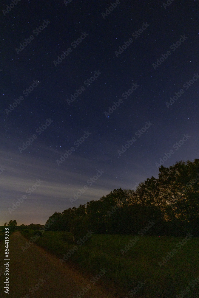 Serene rural nighttime landscape with a starry sky, peaceful and tranquil, showcasing natures beauty under the cosmos Serene rural nighttime landscape with a starry sky, peaceful and tranquil, showcasing natures beauty under the cosmos