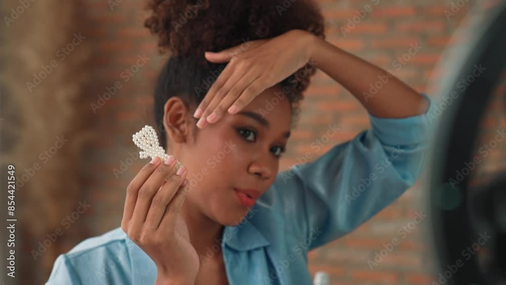 Woman influencer shoot live streaming vlog video review hair clips crucial social media or blog. Happy young girl with apparel studio lighting for marketing recording session broadcasting online.