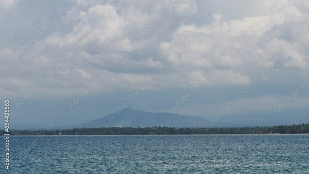 A hill on land seen from the sea