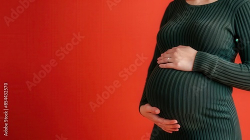 Pregnant woman holding her belly, anemia in pregnancy photo