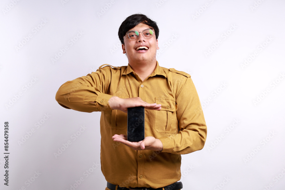 Happy Indonesian government employees standing while showing blank cell phone display Happy Indonesian government employees standing while showing blank cell phone display