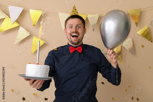 Happy man with birthday cak...