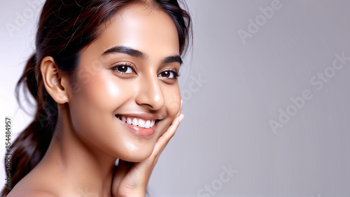 Woman smiling while touching her flawless glowy skin with copy space for your advertisement, skincare 