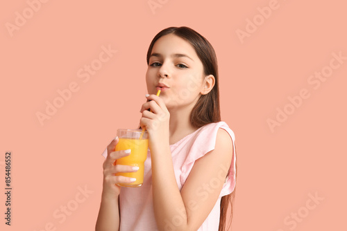 Little girl drinking orange...