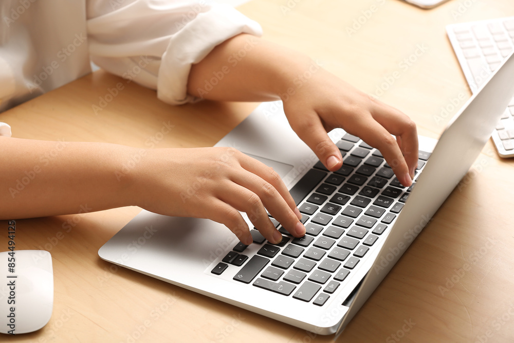 Female programmer typing on laptop keyboard in office, closeup Female programmer typing on laptop keyboard in office, closeup