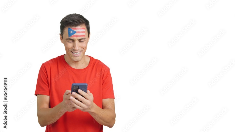 Puerto Rican supporter looking at his mobile smiling and showing it.