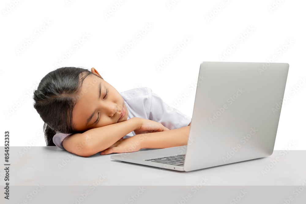 Portrait of an Asian elementary school student girl with a laptop tired of learning on the table Portrait of an Asian elementary school student girl with a laptop tired of learning on the table