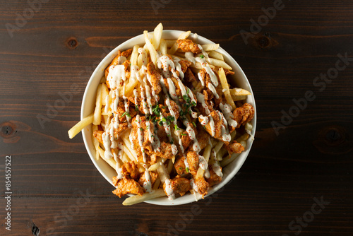 A top down view of a bowl of chicken shawarma fries. photo