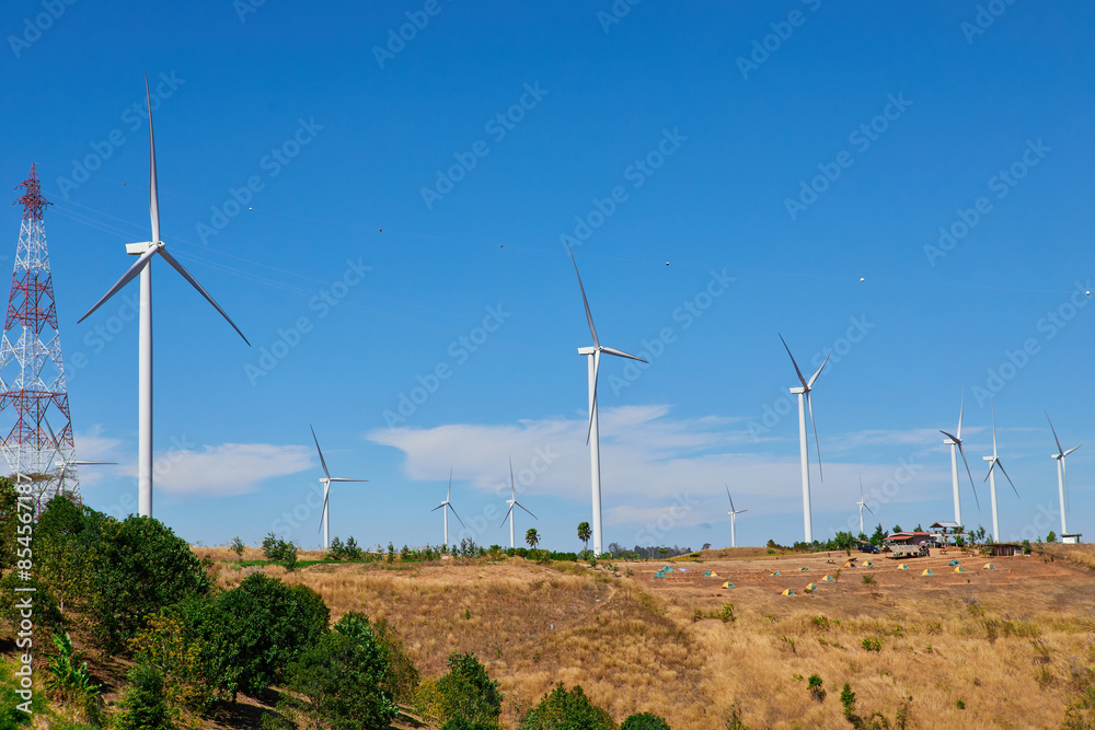 Windmills for electric power production against blue sky Windmills for electric power production against blue sky