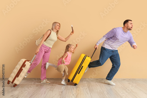 Family running with suitcas...