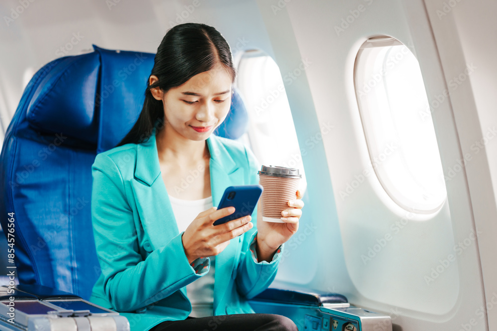 A reliable Asian businesswoman wearing a formal suit airplane passenger, traveling for business or study abroad. She embodies professionalism and determination in an international setting. A reliable Asian businesswoman wearing a formal suit airplane passenger, traveling for business or study abroad. She embodies professionalism and determination in an international setting.
