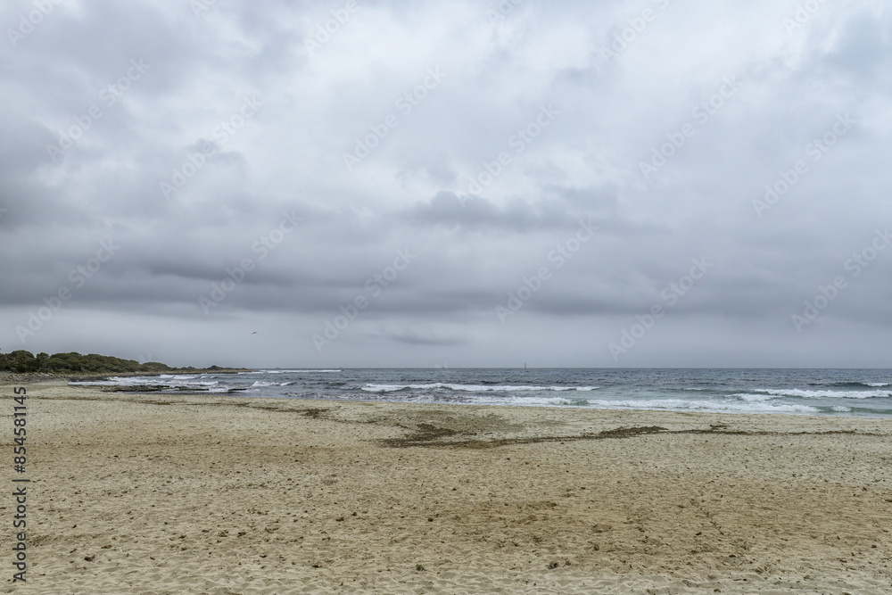Distant Sailboat on Overcast Day at Punta Prima Beach Distant Sailboat on Overcast Day at Punta Prima Beach