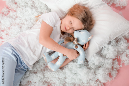 Adorable girl with teddy be...