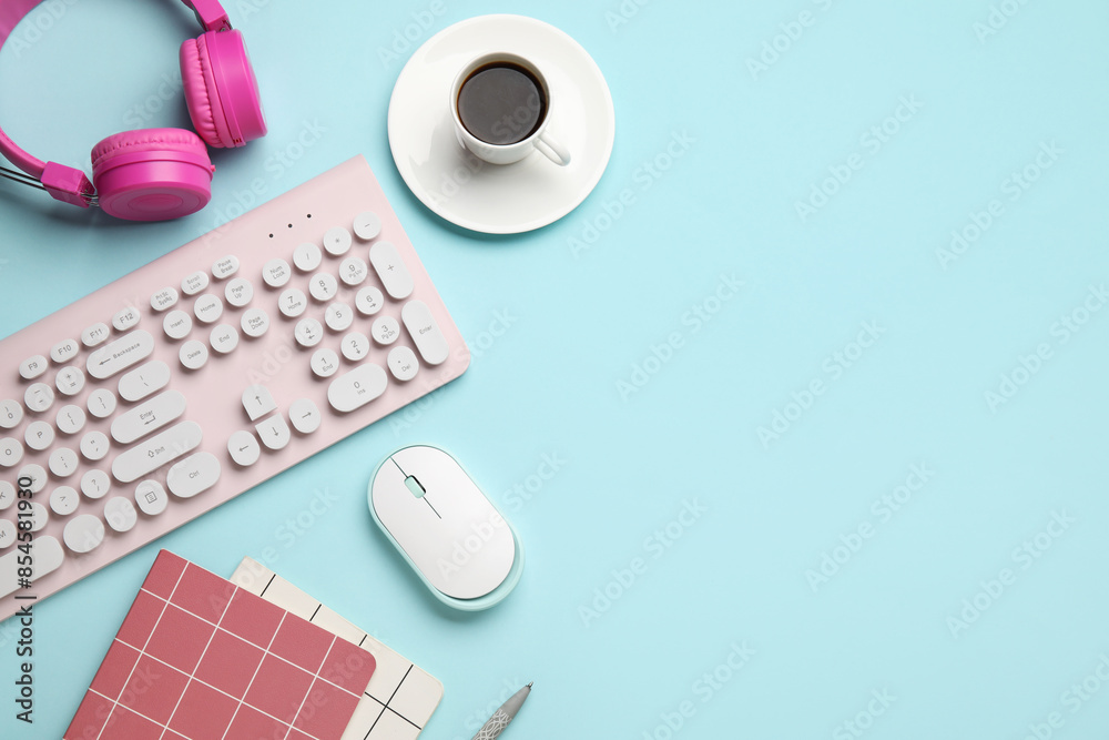 PC keyboard, mouse, headphones, coffee and stationery on blue background PC keyboard, mouse, headphones, coffee and stationery on blue background