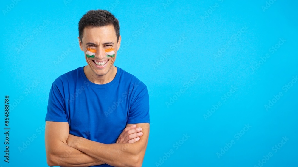Man standing with indian flag painted on face smiling Man standing with indian flag painted on face smiling