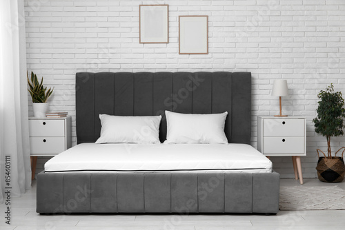 Obraz na płótnie New orthopedic mattress on stylish bed in room