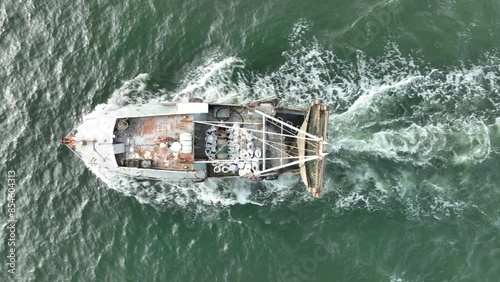 Aerial view of trawler vessel. Fishing boat trauler with sacks full of rapani