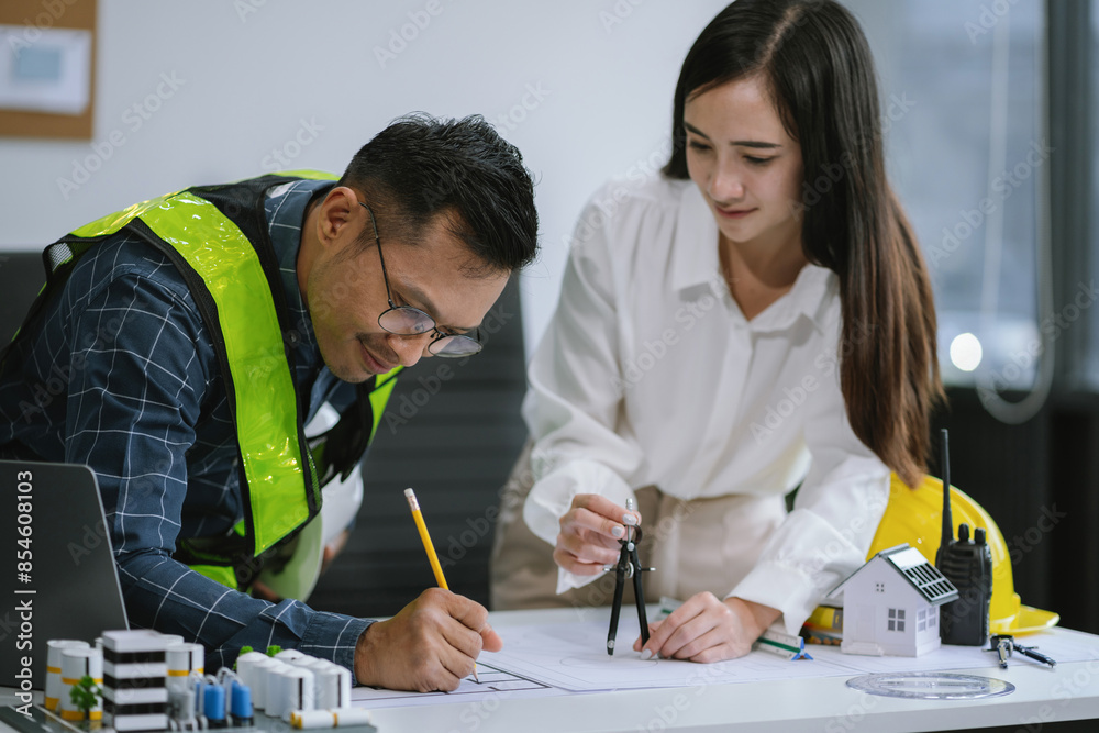 Working as a team architect and designer working on blueprint project of new apartments. Photo concept of work on technical drawings in office. Working as a team architect and designer working on blueprint project of new apartments. Photo concept of work on technical drawings in office.