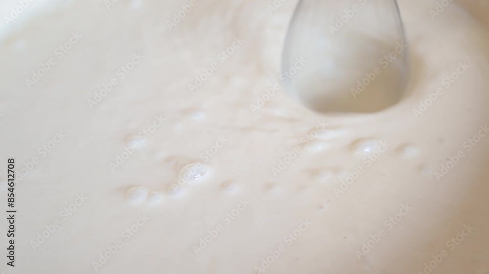The process of mixes dough for pancakes at home. The process of mixes dough for pancakes at home.