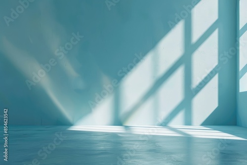 Minimal abstract light blue background for product presentation. Shadow and light from windows on plaster wall.