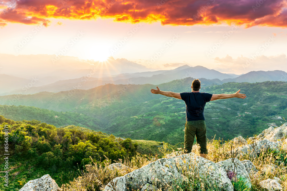 happy man watching amazing highland evening sunset, person delight with nature landscape