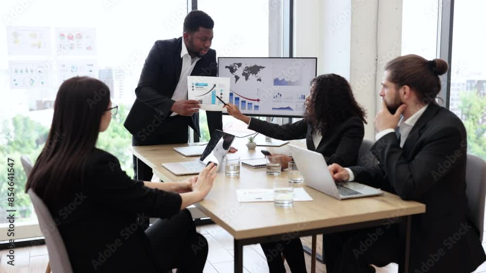 Business team discussing charts and statistics during a meeting in office. Collaborative environment with diverse professionals analyzing data and strategies. Business team discussing charts and statistics during a meeting in office. Collaborative environment with diverse professionals analyzing data and strategies.