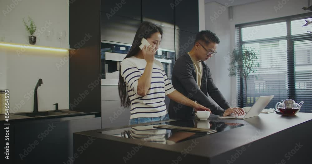 Camera view of two Chinese people using gadgets for working remotely. Young dirl having online conversation with customer on phone. Attractive man working on laptop next to woman. Freelancing concept. Camera view of two Chinese people using gadgets for working remotely. Young dirl having online conversation with customer on phone. Attractive man working on laptop next to woman. Freelancing concept.