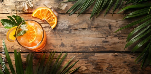 Top view photo of a refreshing cocktail on a wooden table, showcasing a vibrant drink with ice cubes and garnish, perfect for summer relaxation