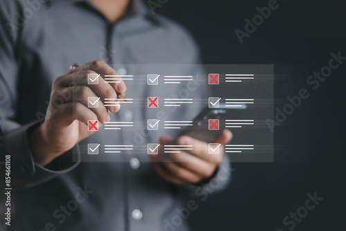 Hands check the checklist manually and fill out the online survey form. Document management system, assessment forms, questionnaires, checklists