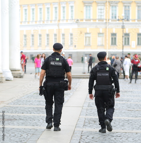 Two policemen on patrol in the city street, Palace Passage, St. Petersburg, Russia, June 17, 2024 photo