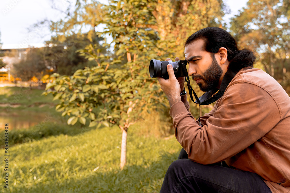 Long-haired, bearded Latino photographer, enjoying and documenting his journey. World photography day. Holidays and travel. Long-haired, bearded Latino photographer, enjoying and documenting his journey. World photography day. Holidays and travel.