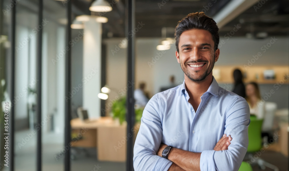 Obraz premium Confident entrepreneur in modern office, arms crossed, embodying startup culture, dressed in smart casual attire, against backdrop of innovative workspace, successful business ventures