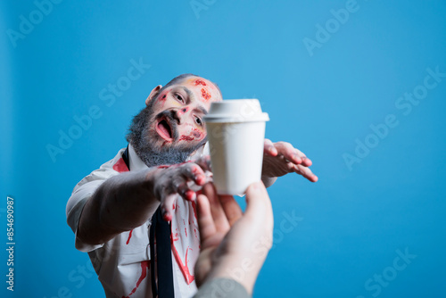 Photos Man starving for coffee, forced by capitalism to maintain productivity all day, being worked to death