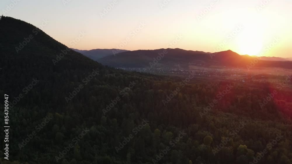 Amazing inspirational epic drone view of tops conifers in beautiful mountains during warm summer sunset. Outdoors lifestyle for healthy and fresh air. Wanderlust destination and nature concept