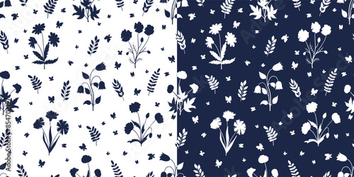 Seamless pattern with white wildflowers silhouettes on dark blue background. Meadow with flowers, grass and butterflies. Monochrome vector print for floral summer design of fabric, wallpaper, cover.