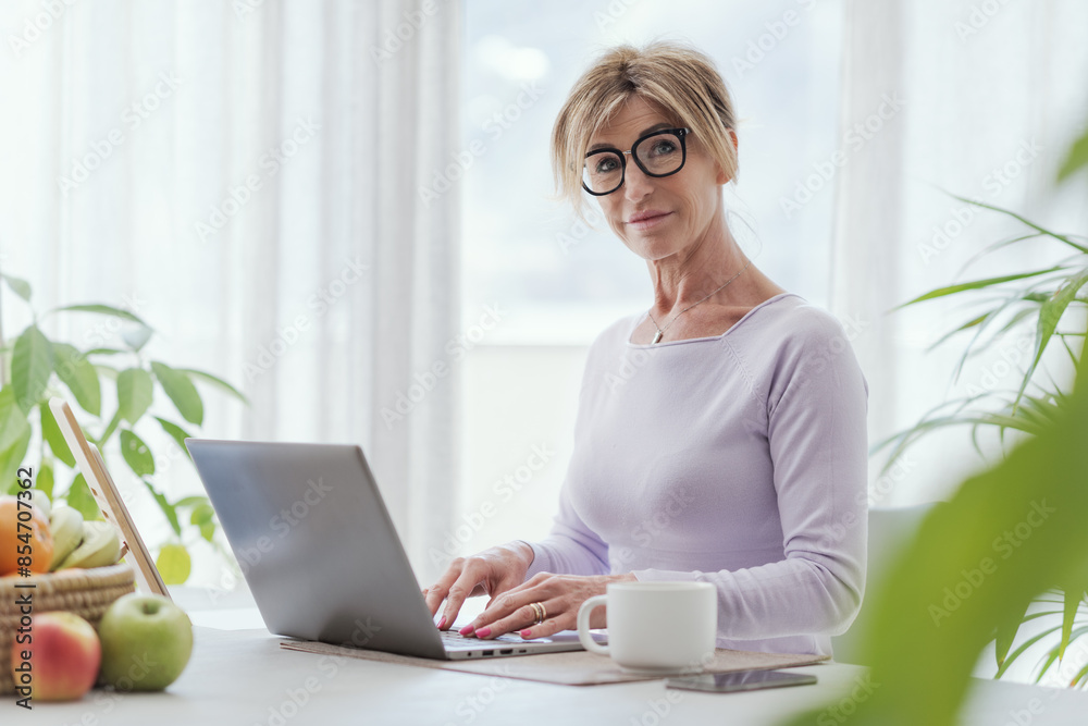 Mature woman using her laptop at home Mature woman using her laptop at home