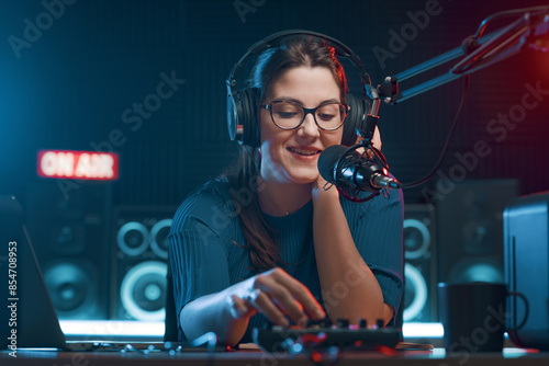 Cheerful radio DJ hosting a radio show photo