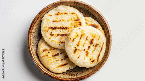 Cornmeal arepas on a plate on light grey background. Traditional flatbread typical for South and Central America countries