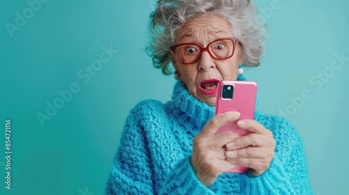 The elderly woman with phone. photo