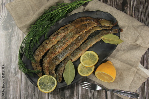 Fried whole lampreys on a plate, Fish delicacies, Latvian cuisine