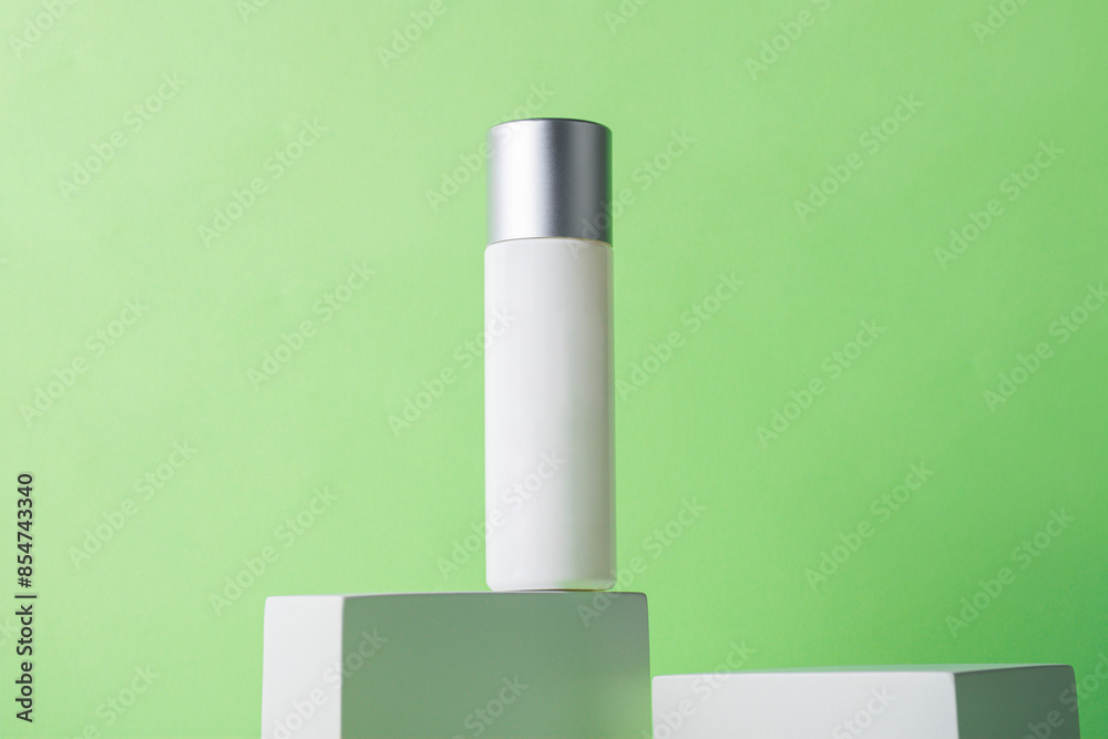 Plastic white tube for cream or lotion. Skin care or sunscreen cosmetic with stylish props on green background. Plastic white tube for cream or lotion. Skin care or sunscreen cosmetic with stylish props on green background.