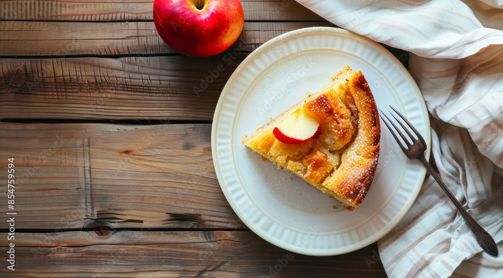 Plate with piece of apple pie on a wooden table, top view.