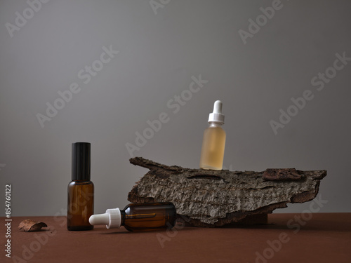 Set of stincare products, empty bottles of beauty priducts on brown and gray background. Product shot with various props.