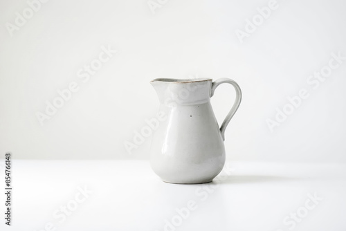 White ceramic pitcher on white background