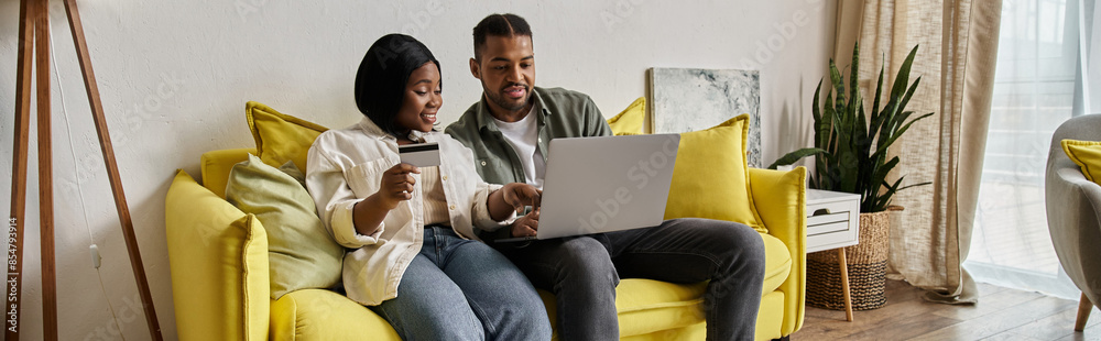 An African American couple enjoys an evening browsing the internet. An African American couple enjoys an evening browsing the internet.