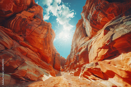 Sweeping Red Sandstone Formations in a Narrow Canyon Under Blue Sky photo