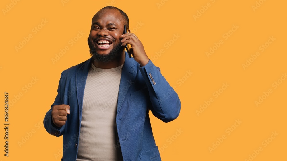 Joyous man with positive emotion, enjoying talking with friends in phone call using smartphone, studio background. Happy person with smile on face, receiving good news during telephone call, camera A Joyous man with positive emotion, enjoying talking with friends in phone call using smartphone, studio background. Happy person with smile on face, receiving good news during telephone call, camera A