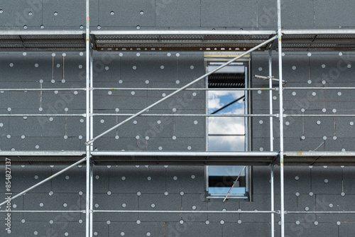 insulating the walls with modern thermal insulation materials. The new house construction process involves Exterior covering is applied at the construction site.